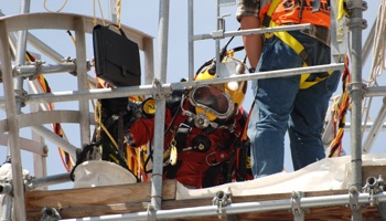 Diver entering steel water storage tank 